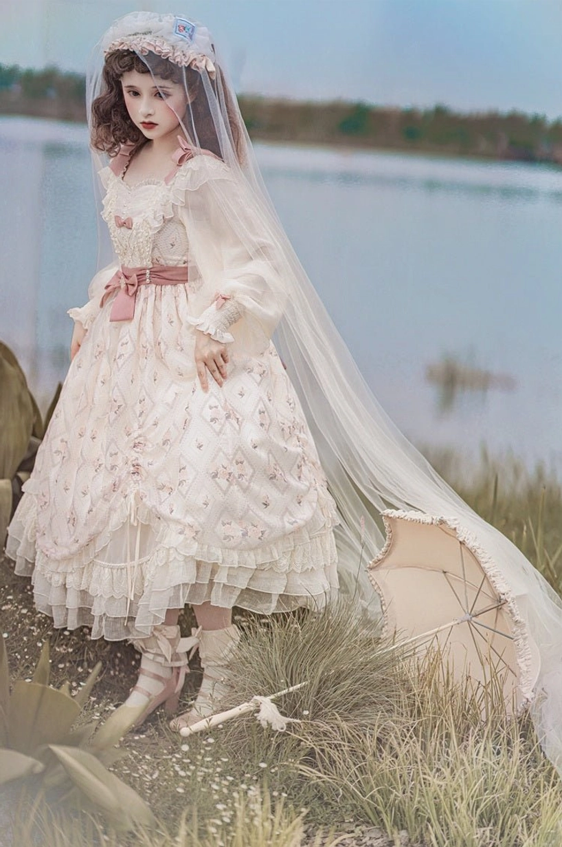 Lolita OP dress bodice and waist construction showing fitted draped bodice, pink waist bow placement, sleeve connection detail, delicate fabric draping technique