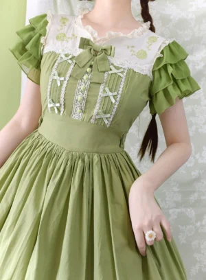Bamboo green classic Lolita one-piece dress upper body close-up showing embroidered lace collar tiered ruffled short sleeves and fitted high waist with pleated skirt