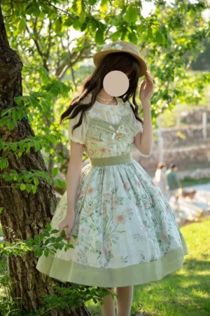 Three-quarter front angle of white cotton lolita one-piece dress featuring all-over floral print and puffed short sleeves with elastic waist