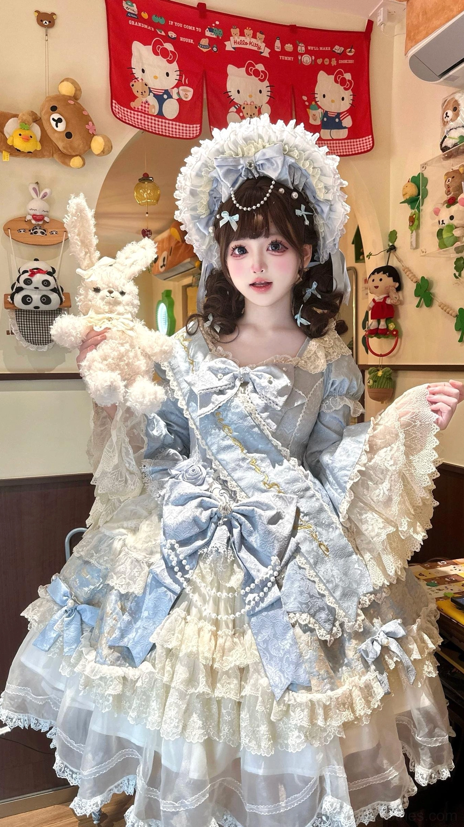 Formal sweet Lolita dress side-three-quarter view model with pearl-decorated bonnet holding plush rabbit detachable lace hand sleeves embroidered fabric