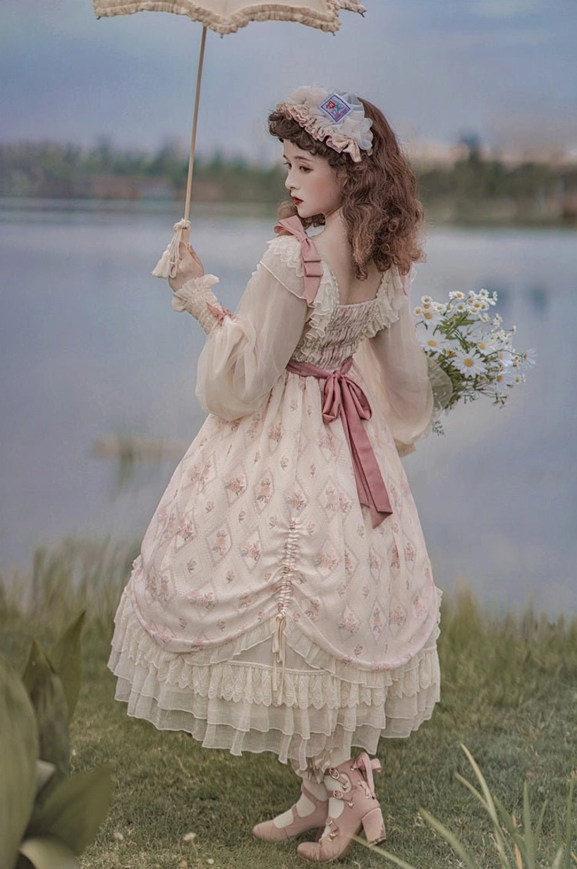 Lolita OP dress full-body three-quarter view showing complete silhouette proportions, tiered ruffled skirt hem, puff sleeves, pink waist bow, romantic voluminous shape