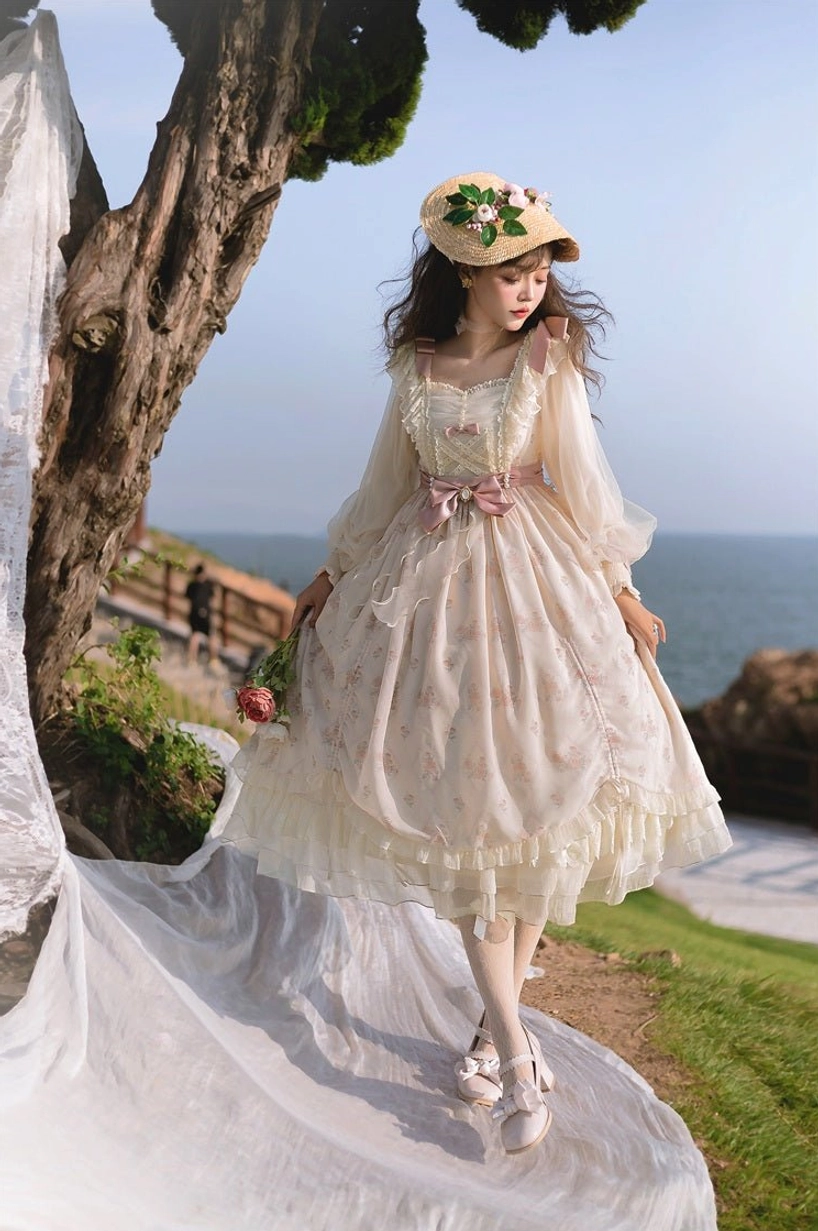 Ivory floral lolita OP dress waist and bow detail featuring large pink statement bow, fitted waistline, delicate floral print, structured bodice with draped construction