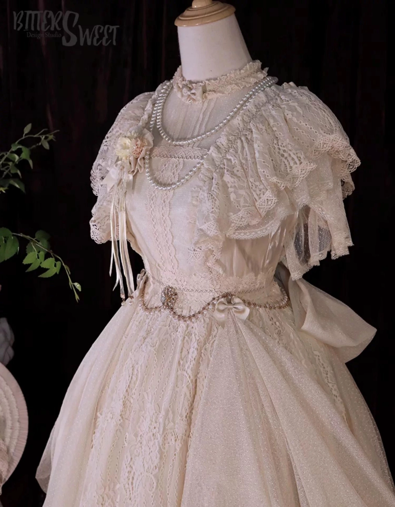 Champagne Lolita OP dress with optional pearl waist chain and matching lace sleeves add-ons modeled together for enhanced coordinate and styling versatility