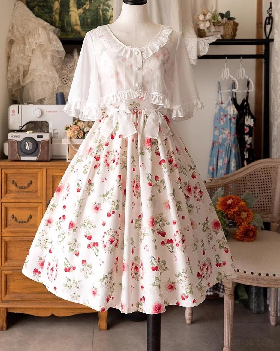 Complete Lolita coordinate featuring red berry print midi dress with matching white ruffled cropped cardigan, elegant A-line silhouette with vintage furniture studio backdrop