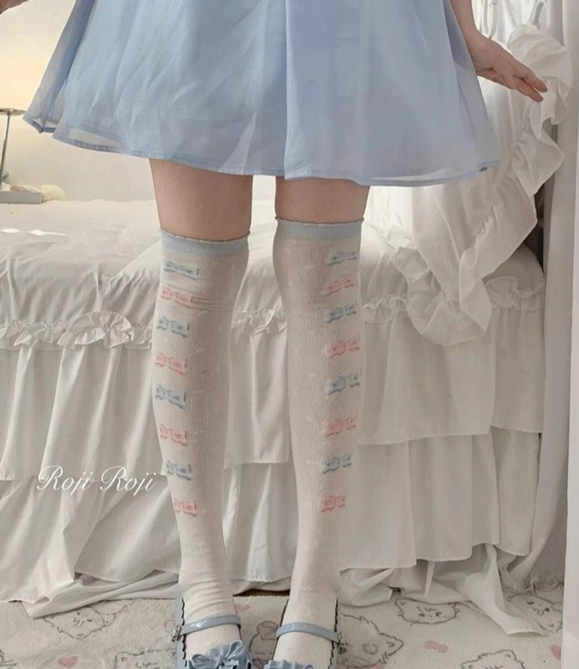 Lolita over-the-knee socks light blue pastel bow letter prints blue ruffled skirt blue platform mary janes three-quarter front view