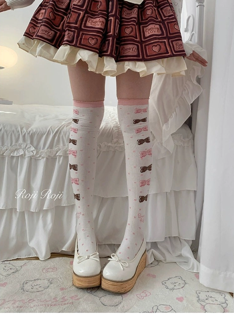 Lolita over-the-knee socks pink and coffee bow print vertical stripes side strap details red heart-print skirt platform loafers full leg front view