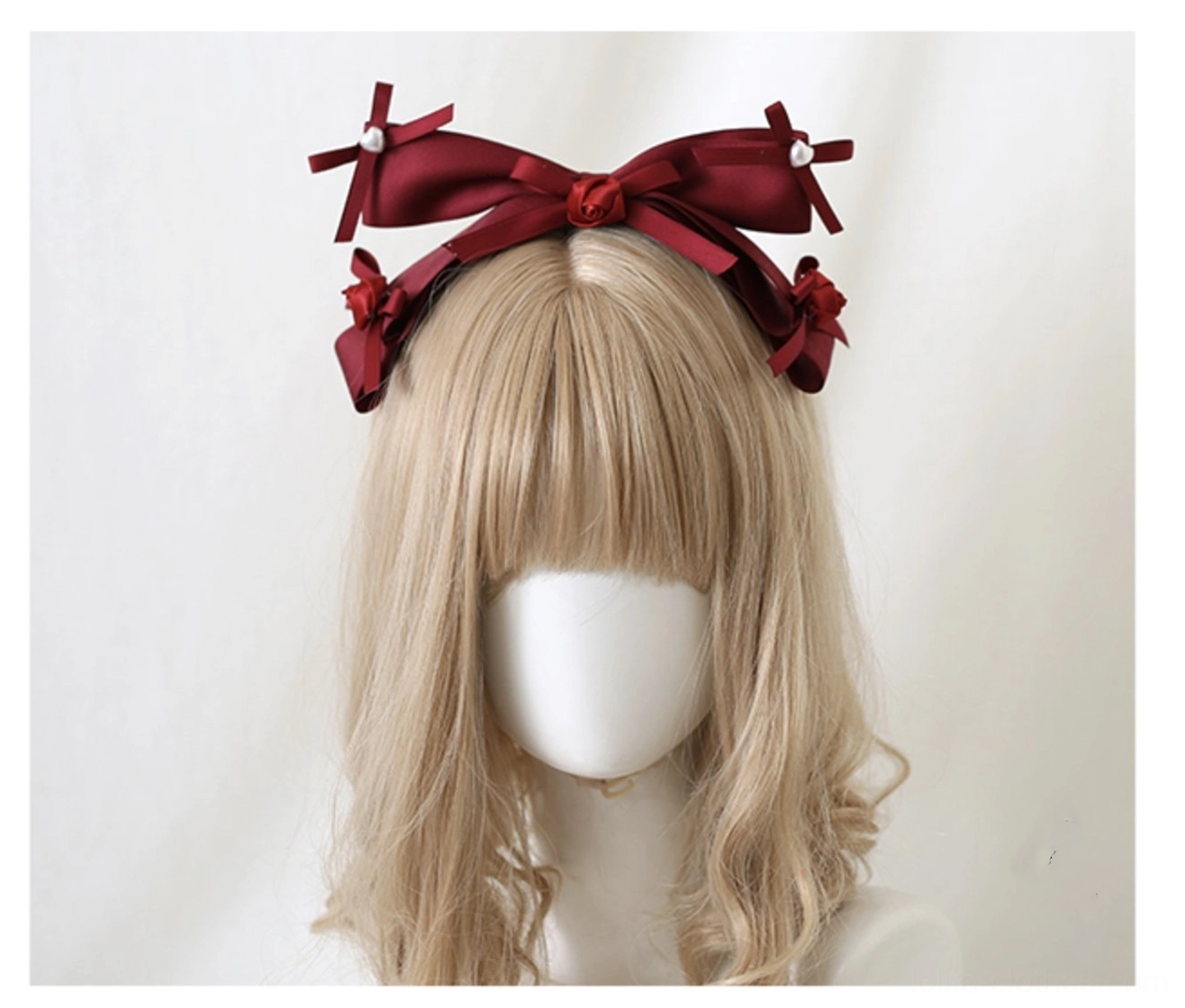 Lolita oversized dark red satin bow hair clips front view on straight bangs blonde wig mannequin featuring sweet lolita style with small matching bows