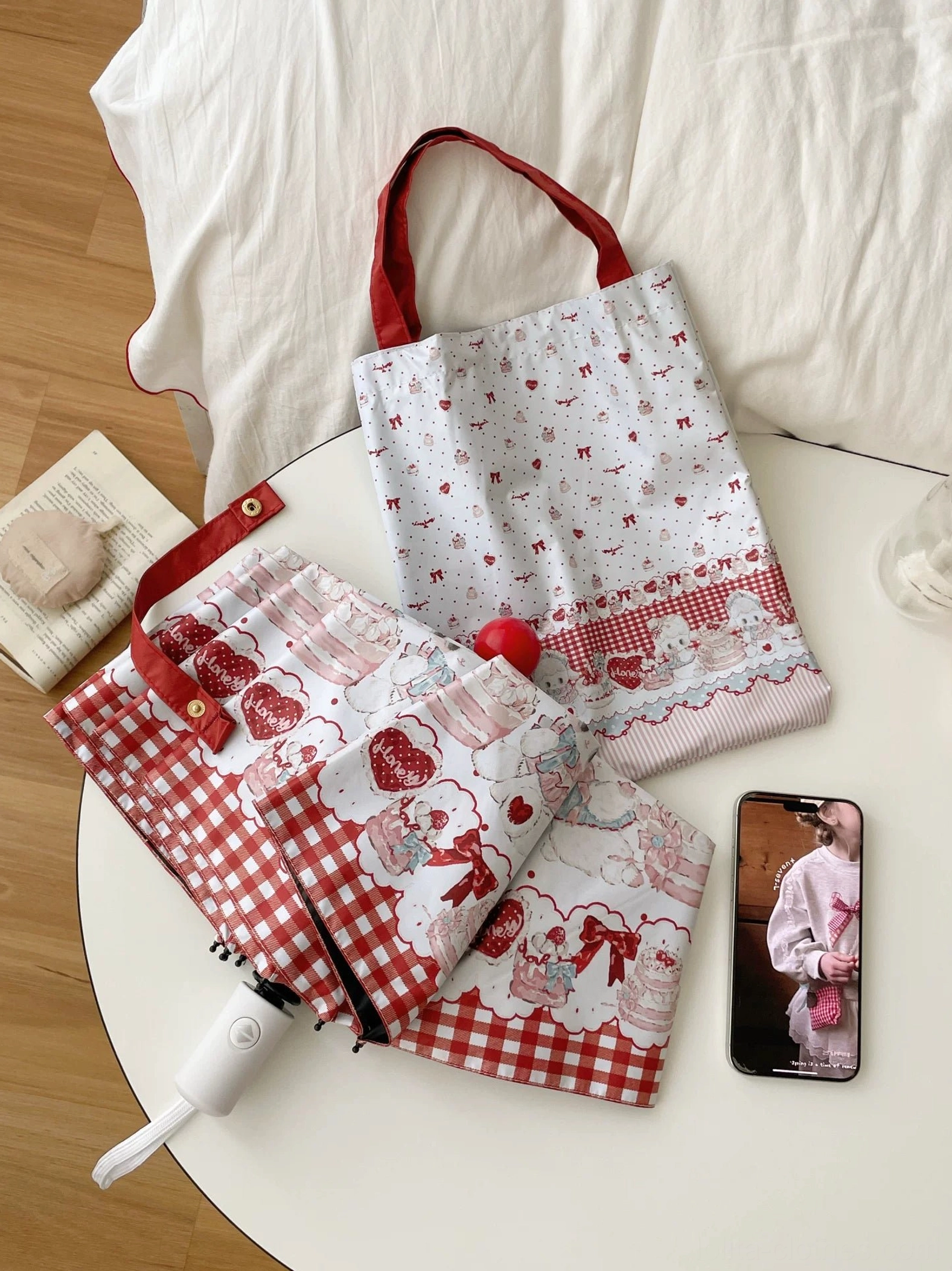 Automatic lamb printed lolita parasol folded on white desk with matching tote bags in minimalist home workspace