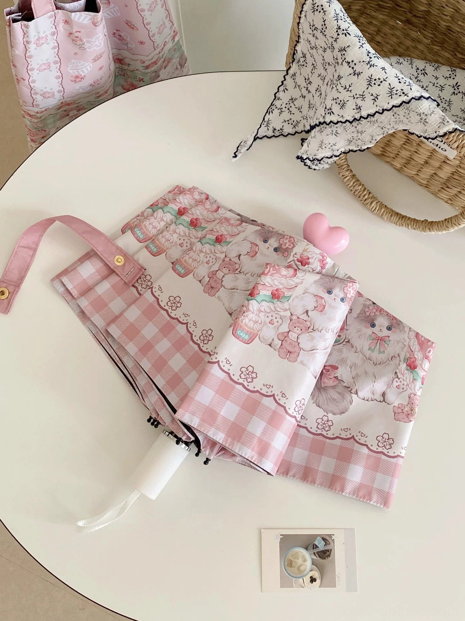 Manual sakura cat printed lolita parasol with pink heart button on white background tabletop display