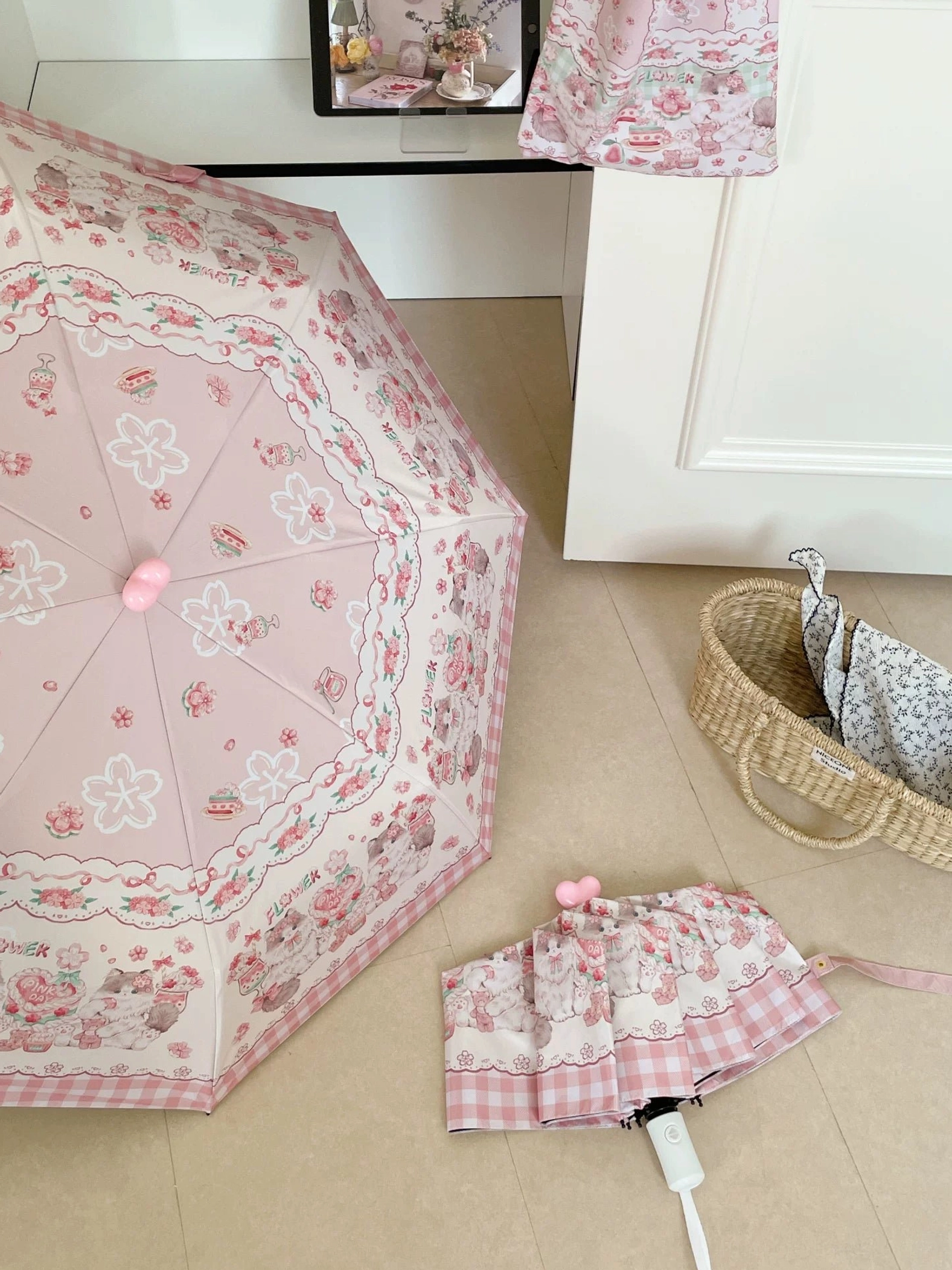 Pink base lolita parasol with floral cartoon print showing both folded compact form and fully opened umbrella