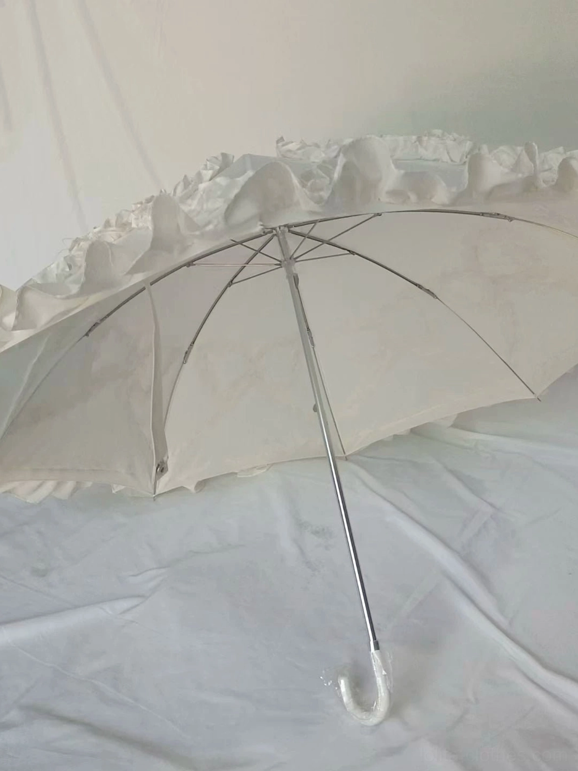 Lolita parasol styling guide photograph showing multiple color options from ivory to pink to black on neutral background, reference image for coordinate planning