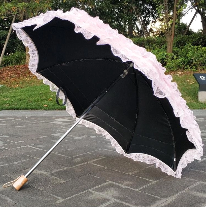 Wooden handle and metal components of Lolita parasol featuring hybrid construction design for ergonomic grip and vintage aesthetic appeal