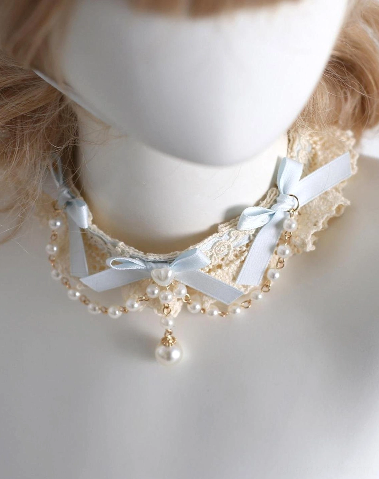 Lolita pearl lace choker necklace with cream ruffled collar sky blue bows and dangling pearl pendant gold hardware close-up