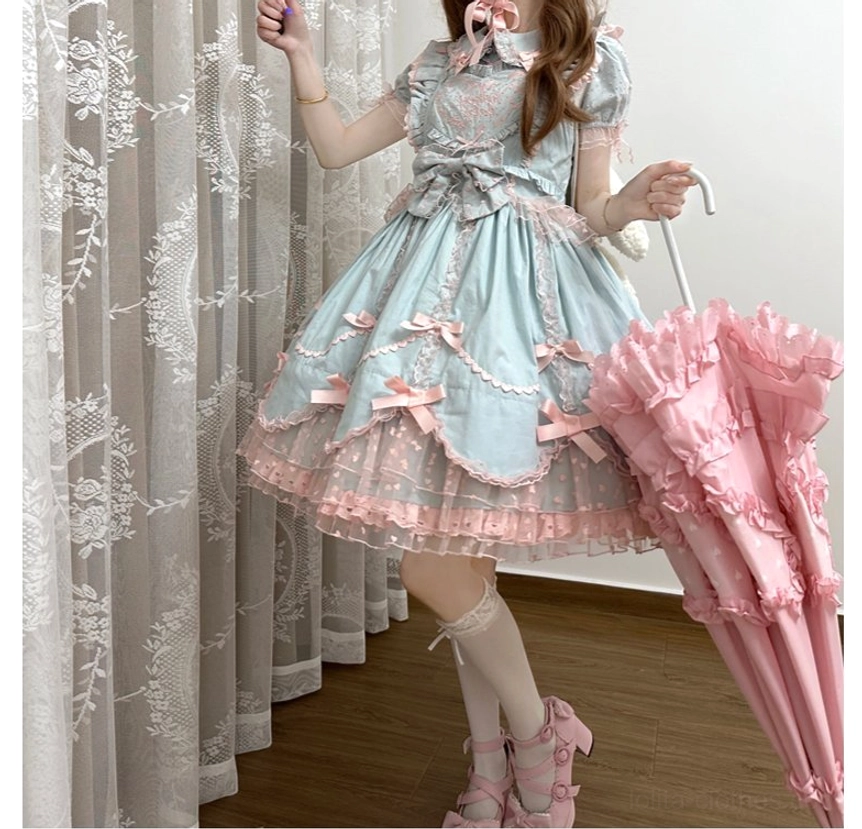 Detailed view of sweet Lolita dress petal-shaped hem construction with embroidered tulle layer