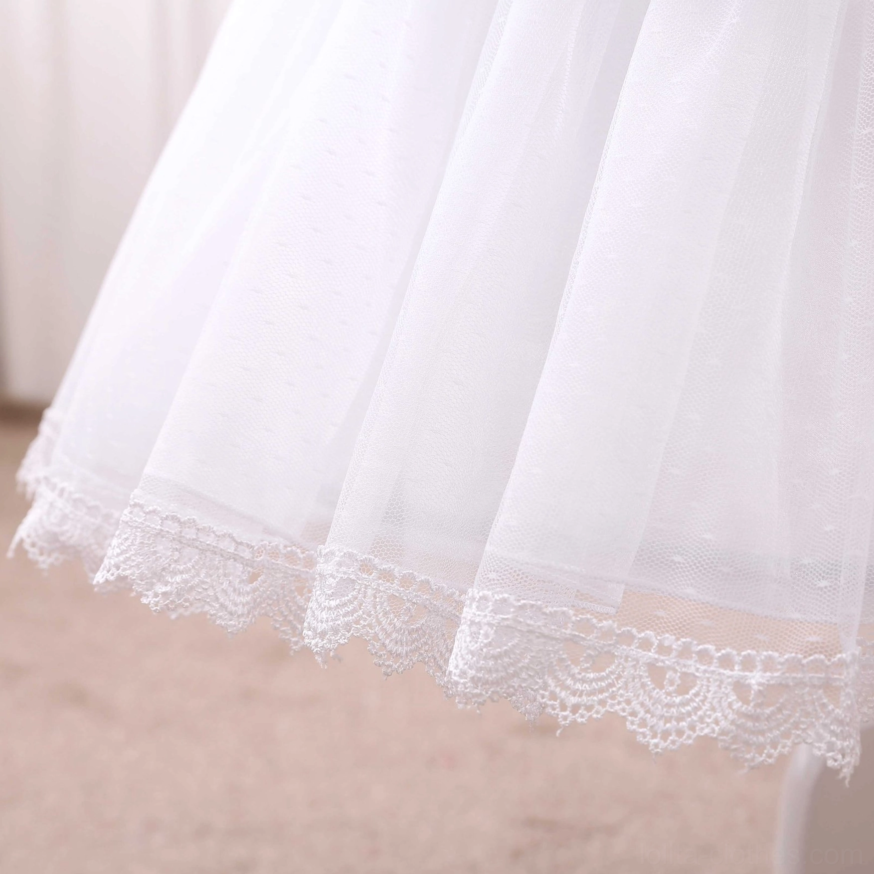 close-up lolita petticoat hem detail dotted tulle fabric embroidered lace trim layered ruffled construction side view