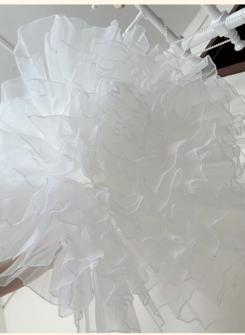 Lolita petticoat ruffle detail extreme close-up showing dense clustered ruffled tulle with soft three-dimensional fluffy texture and layering