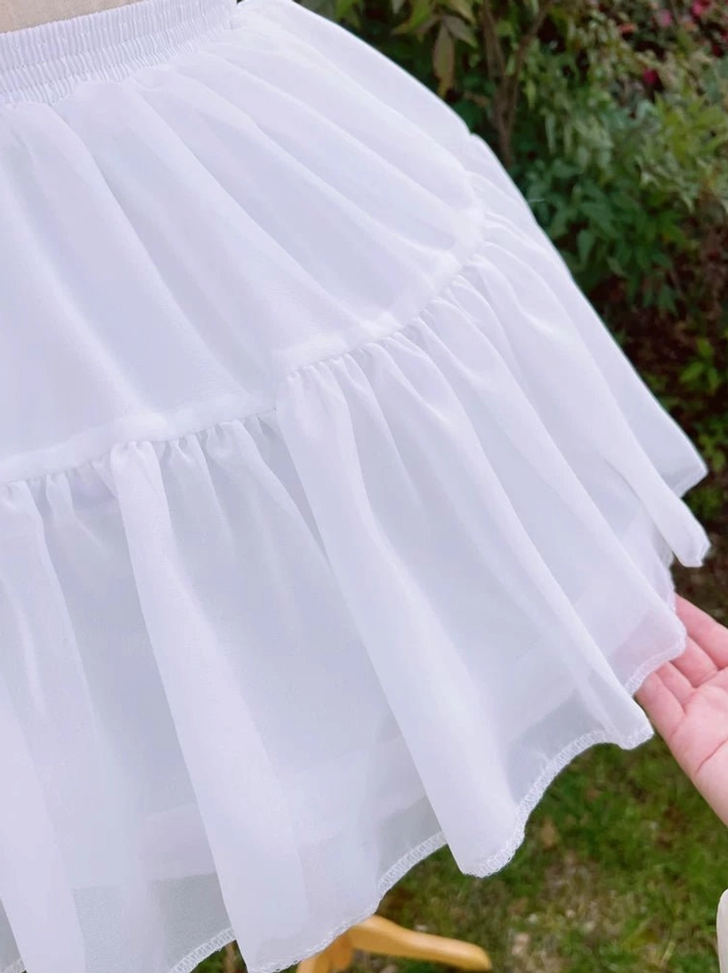 Side close-up lolita petticoat skirt fabric sheer ruffled layered soft flared drape detail outdoor garden