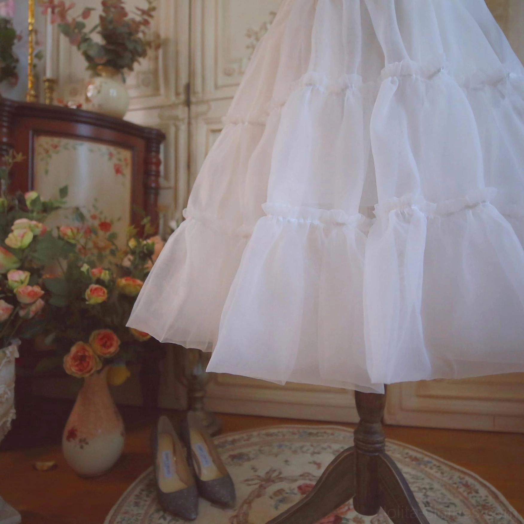 Close-up detail of white Lolita petticoat hem showing fluffy tulle layers neat ruffled edge trims texture