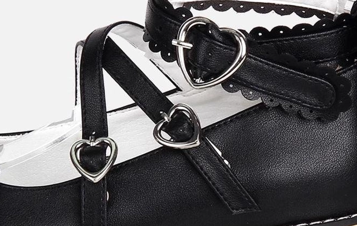 Detailed close-up of Princess Lolita shoes ankle straps showing silver heart-shaped metal buckles, double-cross strap design, and delicate lace trim edge treatment