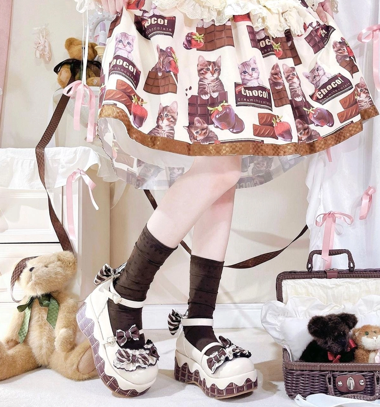 Black and white lolita platform shoes with bowknot details and brown-white contrasting thick sole worn with chocolate-themed printed lolita skirt picnic scene