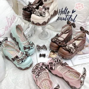 Multiple pairs of lolita platform shoes in brown mint green and pink shades with bow decorations polka dot insole and chocolate-patterned chunky sole flatlay display