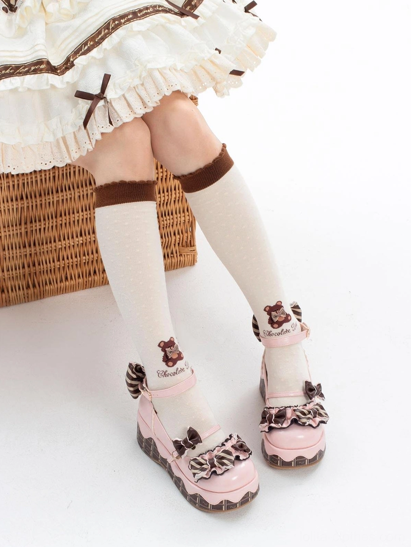 Pink bear-themed lolita platform shoes with bear embroidery on ankle strap bowknot decorations worn on-foot with white knee-high brown cuff socks wicker basket