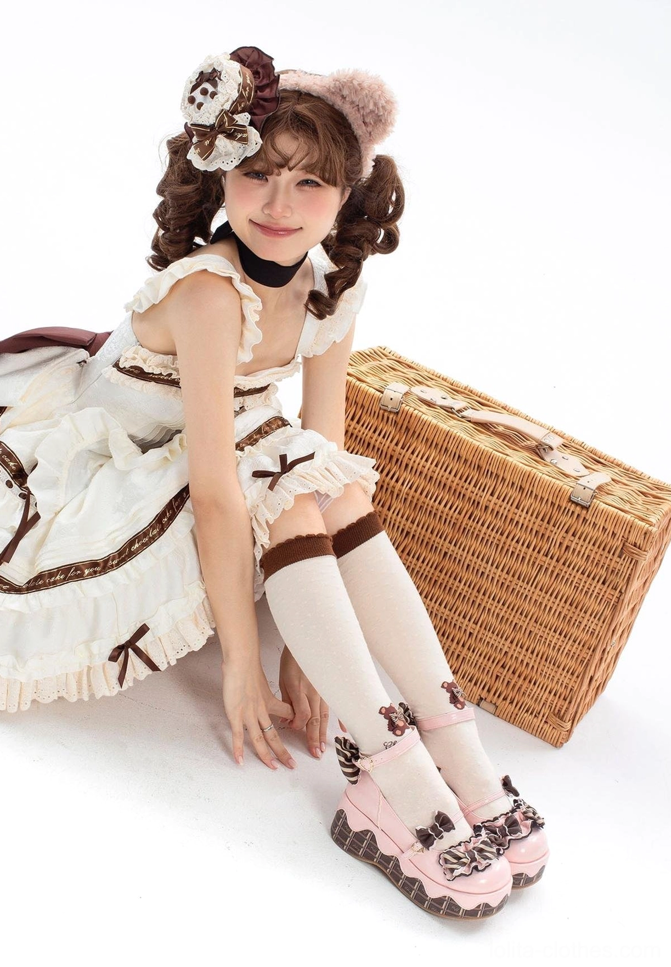 Pink sweet lolita platform shoes with bowknot decorations and chocolate-striped thick sole worn by lolita model in classic sweet lolita dress with hair flower picnic scene