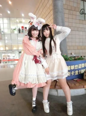 Sweet Lolita fashion shoot featuring two girls wearing vintage lolita dresses in indoor shopping mall, one wearing matching black patent platform shoes with bow details