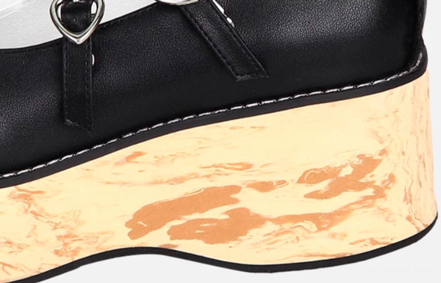 Side close-up detail of Princess Lolita platform sole showing wood grain printed texture, black leather strap with heart-shaped buckle, and clean edge stitching
