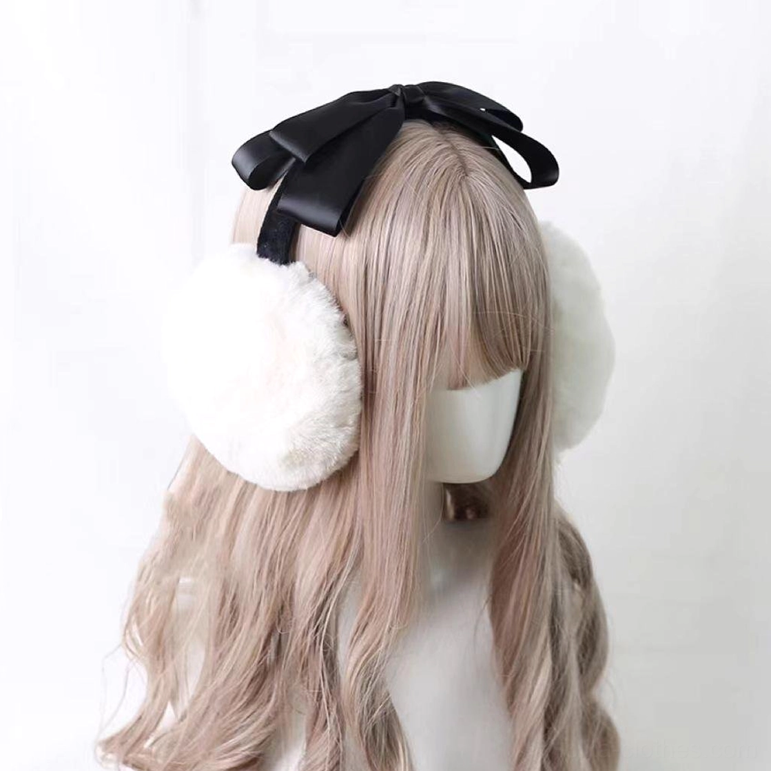 Lolita plush earmuff headdress with black satin bow worn on mannequin showing rear view, white fuzzy ear cups with black headband strap, winter lolita accessories