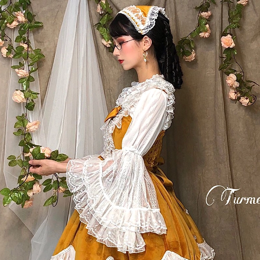 Lolita princess sleeve blouse side profile showcasing elegant sleeve construction and lace cuff details with vintage backdrop