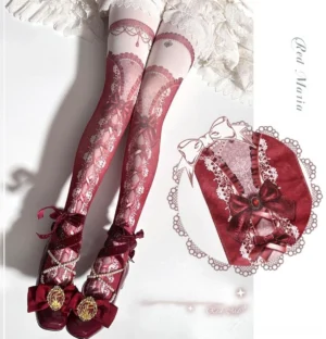 Model wearing retro red digitally printed lolita pantyhose with delicate bow and criss-cross lace-up design, paired with ornate lolita mary jane shoes and white frilly skirt, overhead view