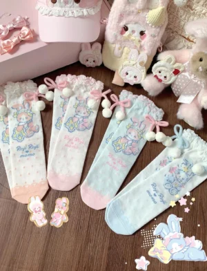 Overhead flat lay view of kawaii lolita rabbit print mid-calf socks in multiple pastel color variants including pink white, pink green, orange pink, and blue white, displaying delicate bunny prints, pom-pom bow cuff decorations, and sweet lolita plush toy props on wooden table background