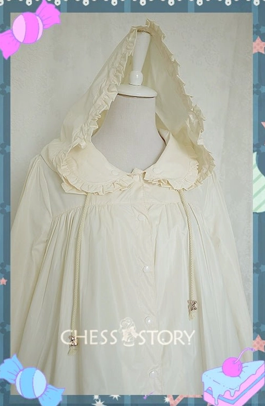 Three quarter front side view cream hooded Lolita raincoat with ruffled collar and hood trim decorative charm and matte fabric