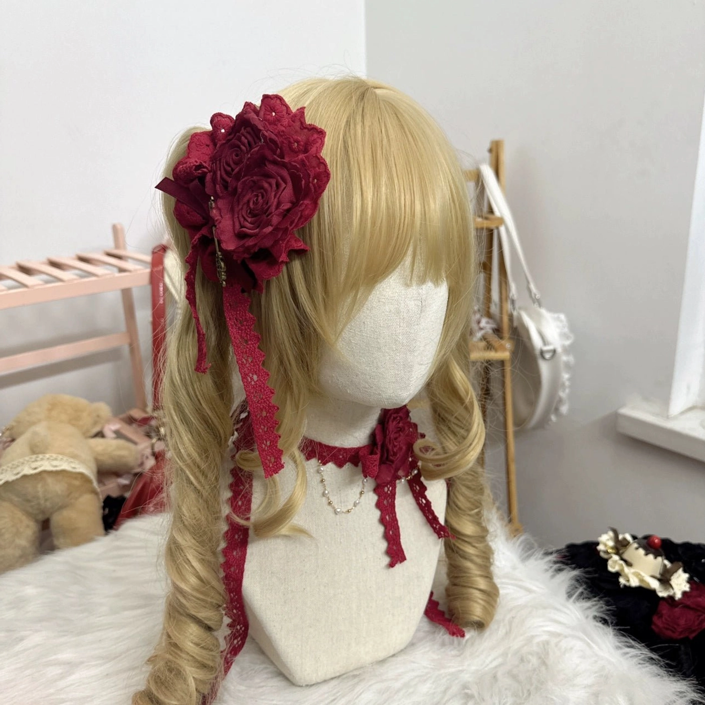 Lolita red rose flower headdress with burgundy fabric rose hair clip and matching red lace choker set displayed on blonde wig with trailing ribbons