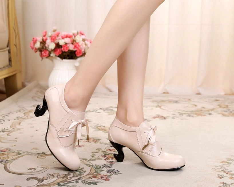 Lolita retro Mary Jane heels showcasing vintage aesthetic elements including deep mouth design, curved spool heel construction, ribbon lace closure system, and delicate scalloped detailing