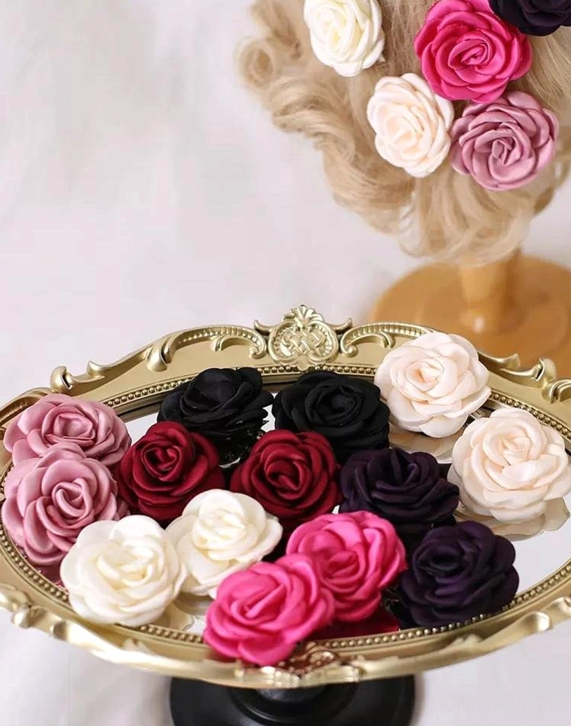 Collection of handcrafted vintage fabric rose brooches and hair clips in multiple Lolita fashion colors displayed on ornate golden serving tray