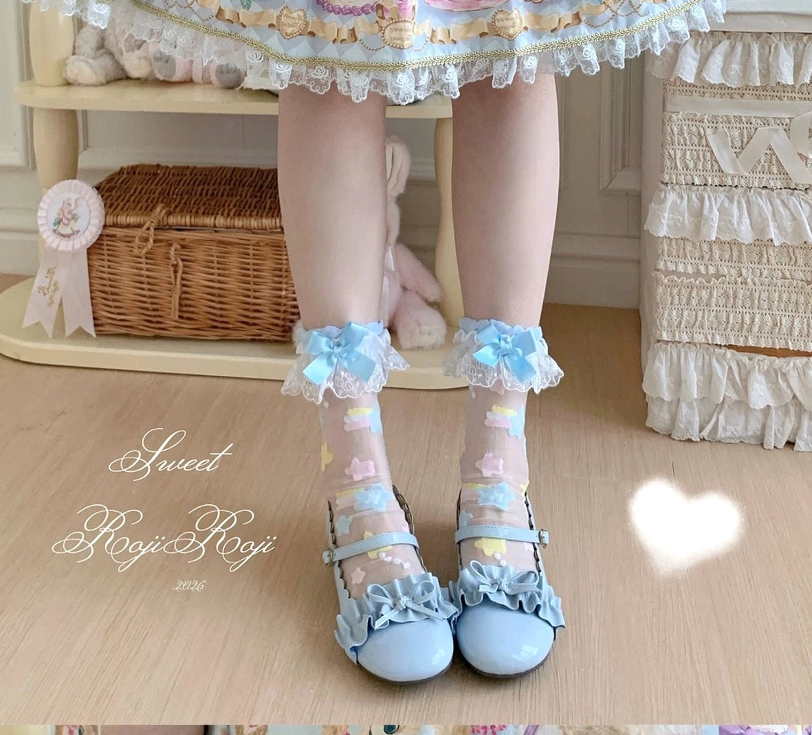Close-up sheer lolita socks star embroidery pattern lace ankle ruffles satin bow details texture