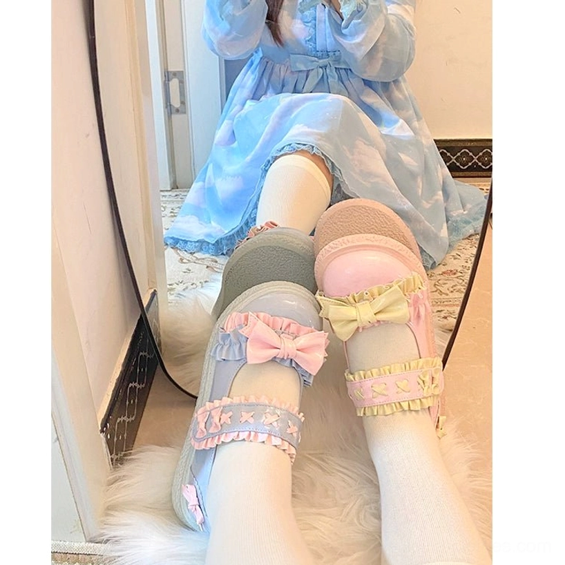 Candy-colored Lolita shoes worn with elaborate Lolita fashion ensemble featuring layered skirts, bloomers and coordinated leg wear on convention floor