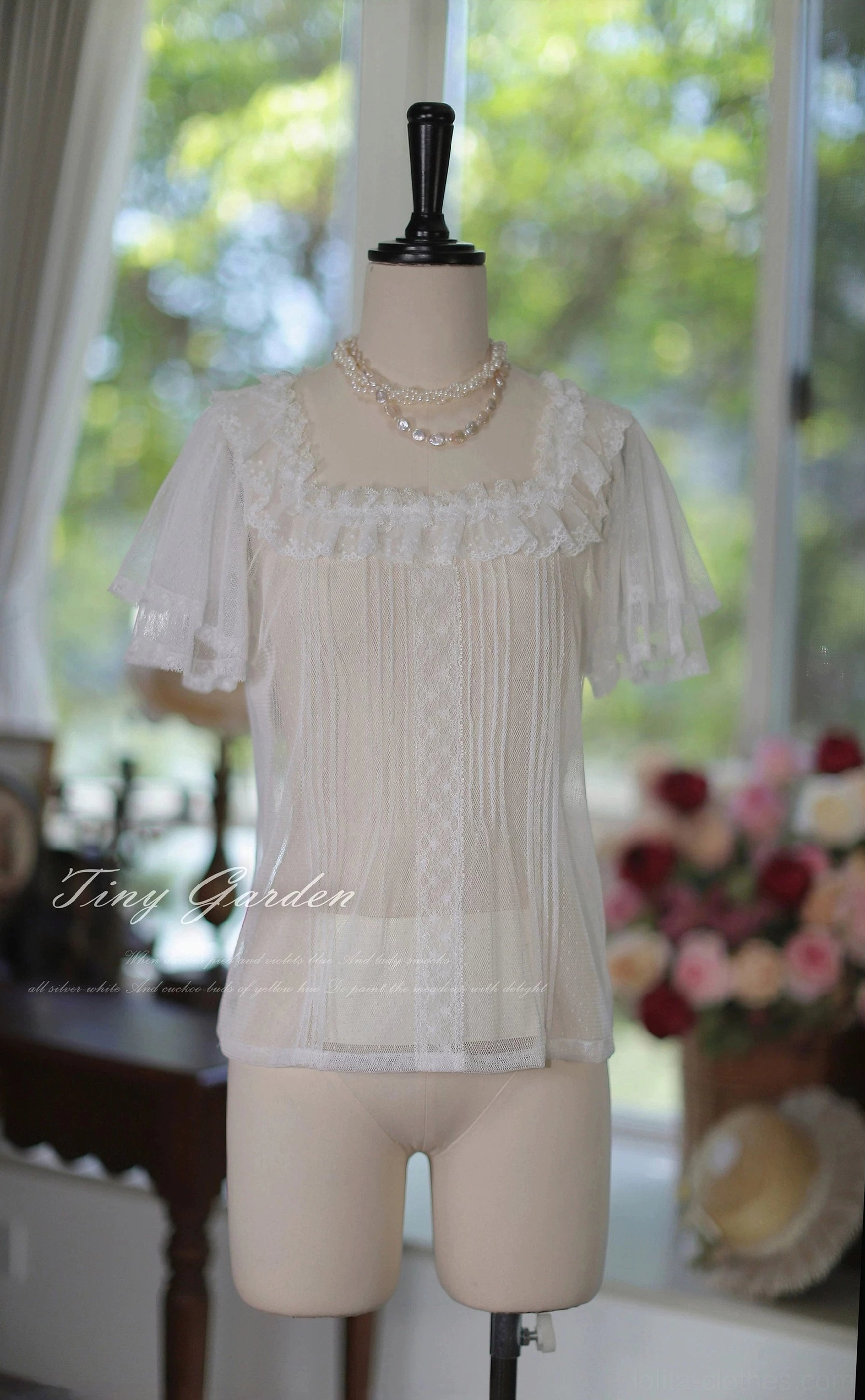 Close-up front detail of classic lolita square neck tulle blouse showcasing delicate lace ruffle neckline, vertical pintuck stripes across fitted bodice and pristine off-white tone with refined vintage aesthetic