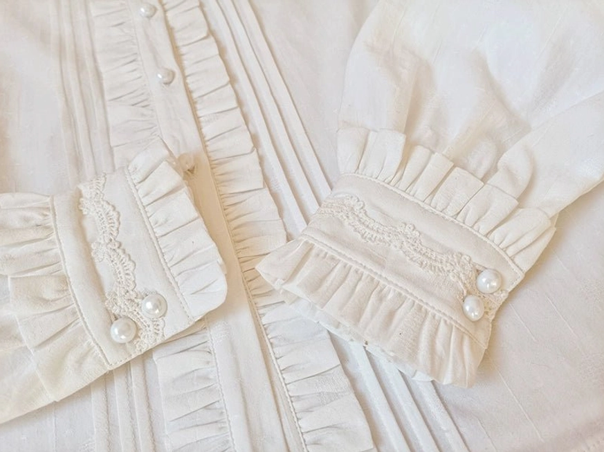 Lolita blouse front placket and ruffled lace cuffs with pearl buttons detailed flat lay view