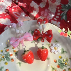 Lolita strawberry pendant necklace with imitation pearl beads and polka dot bow on decorative porcelain plate floral background