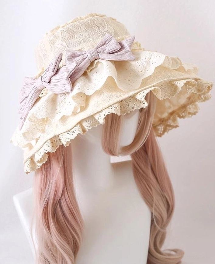 Beige Lolita sun hat with pinkish-purple detachable bows, right front angle showing scalloped hollow lace brim design and vintage aesthetic
