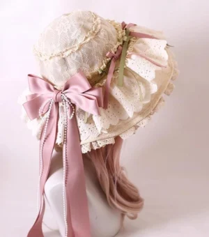 Elegant beige lace lolita sunshade hat with large pink satin bow and streamers, worn on mannequin with pink wig, back oblique view showing detailed eyelet ruffled brim and pearl tassel decorations