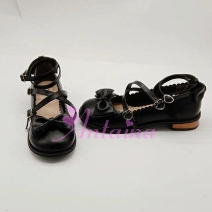 Matte black lolita tea party shoe with gothic aesthetic, crossover ankle strap, toe cap bow accent, and classic low block heel