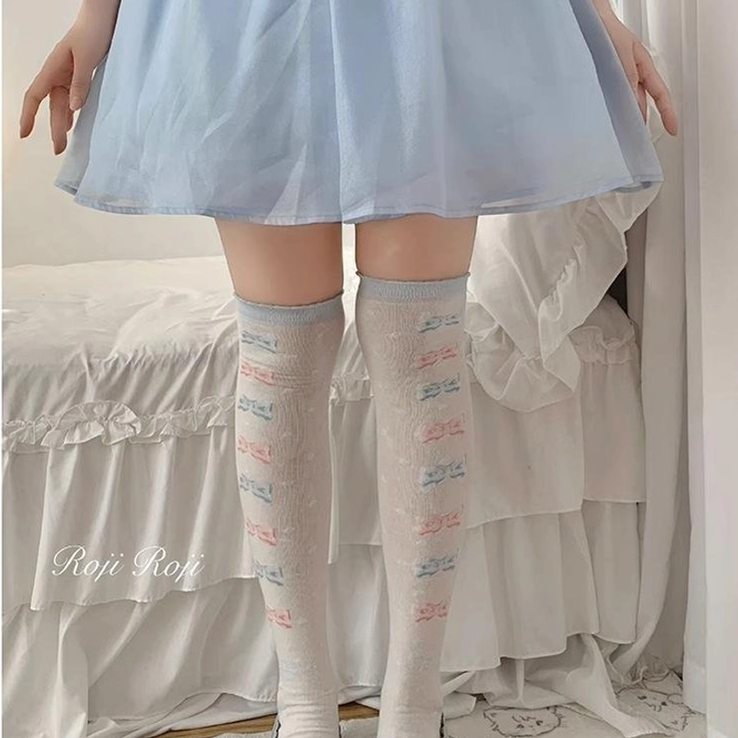 Sweet lolita thigh-high socks light blue ribbed texture repeating pastel bow text prints blue ruffled skirt platform mary janes full leg front view