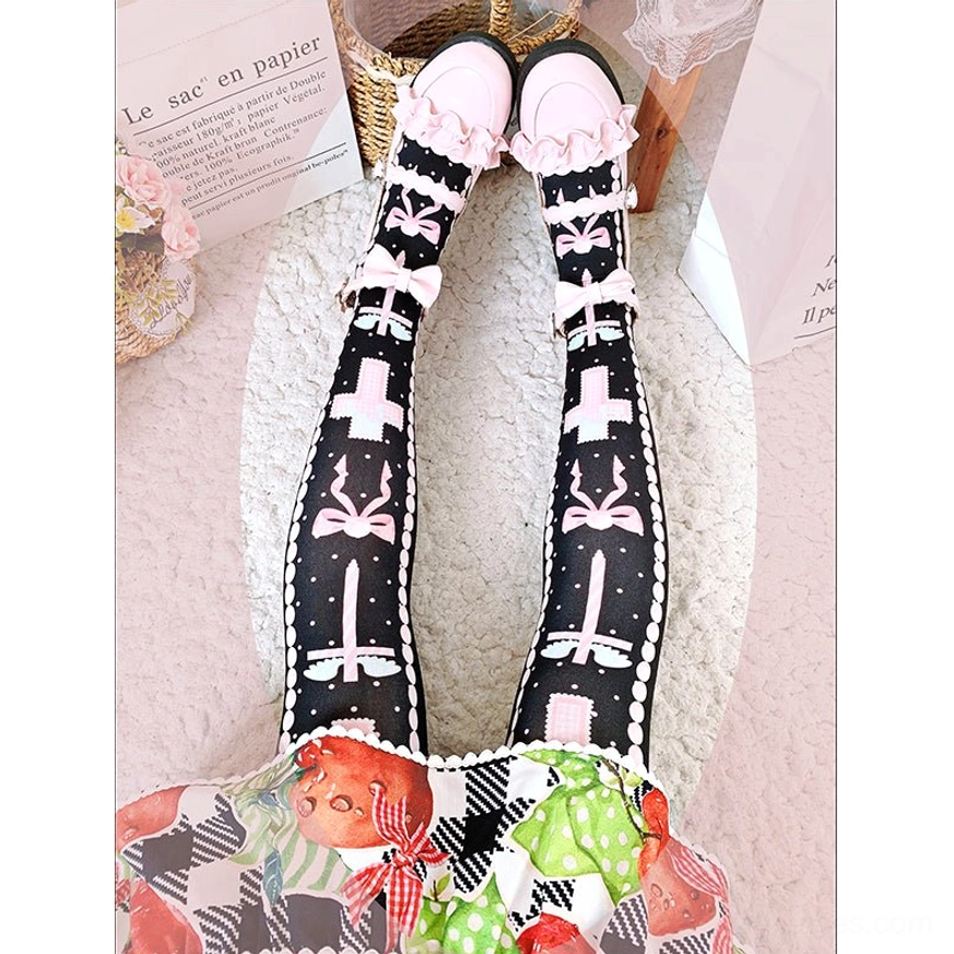 Top-down overhead view of lolita thigh high stockings worn with fruit print dress, showcasing cross bow and decorative motif details