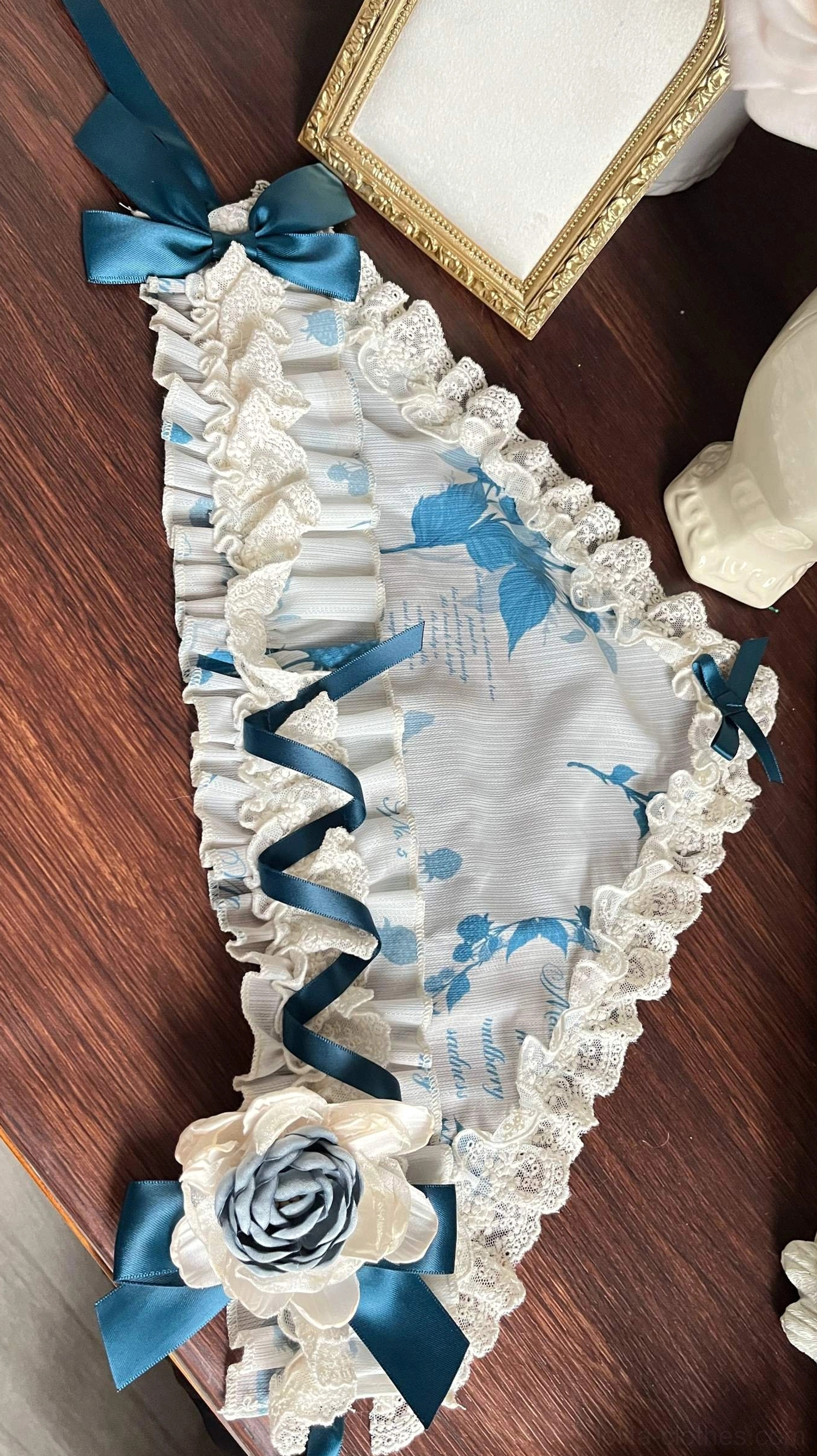 Lolita fabric waist sash neck bow accessory with white base blue vintage floral print ruffled lace edges and fabric flower brooch detail