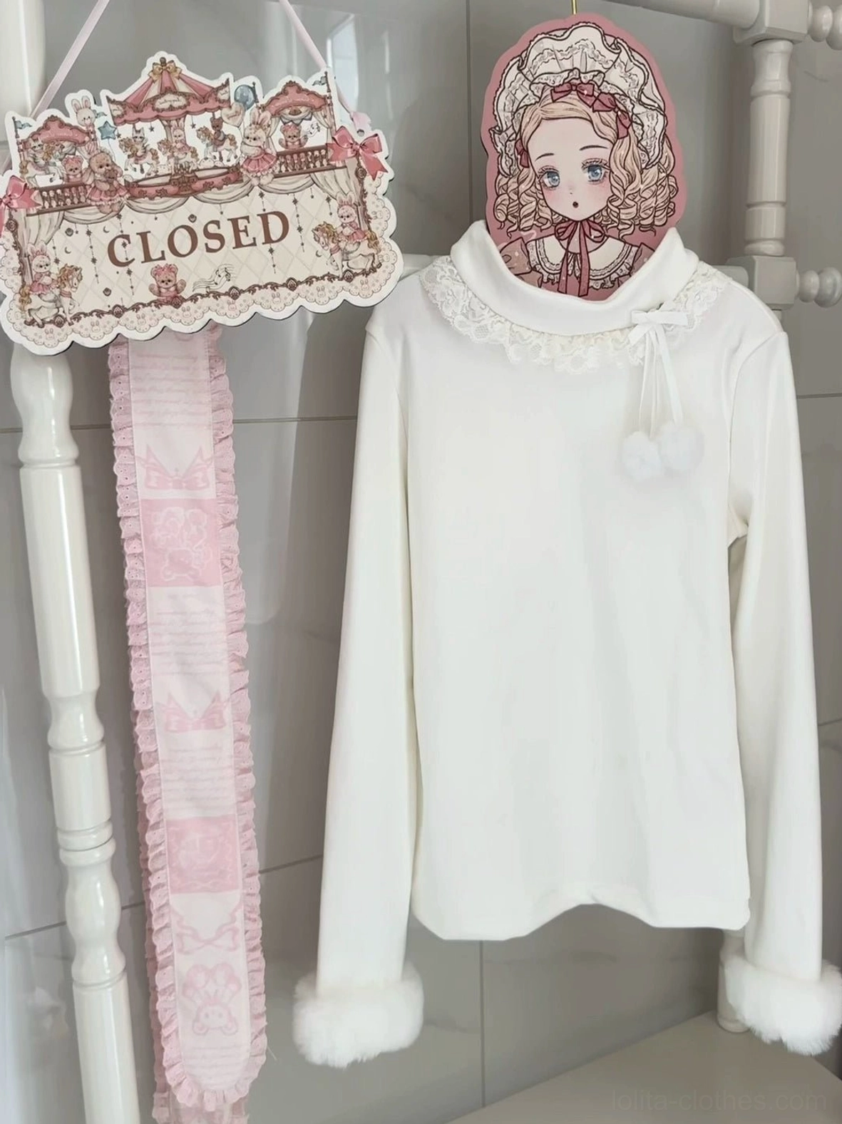 Off-white Lolita winter inner top with lace-trimmed turtleneck fluffy pompom collar details and fluffy faux fur cuffs displayed with matching lace scarf