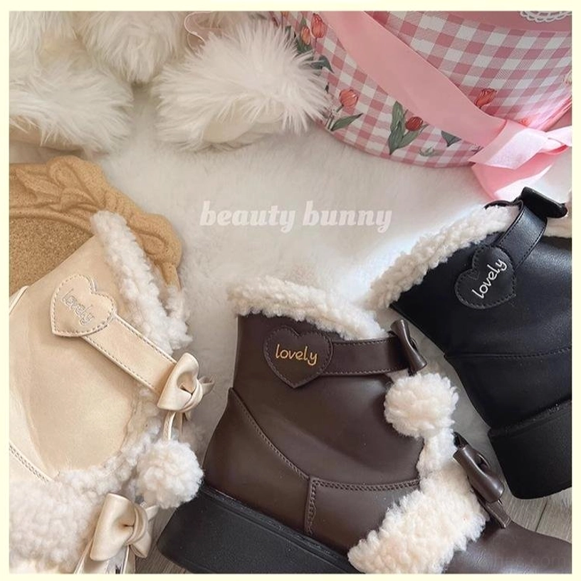 Close-up shots of lolita winter boots with heart-shaped brand tag lovely lettering fuzzy shearling accents and bow strap details